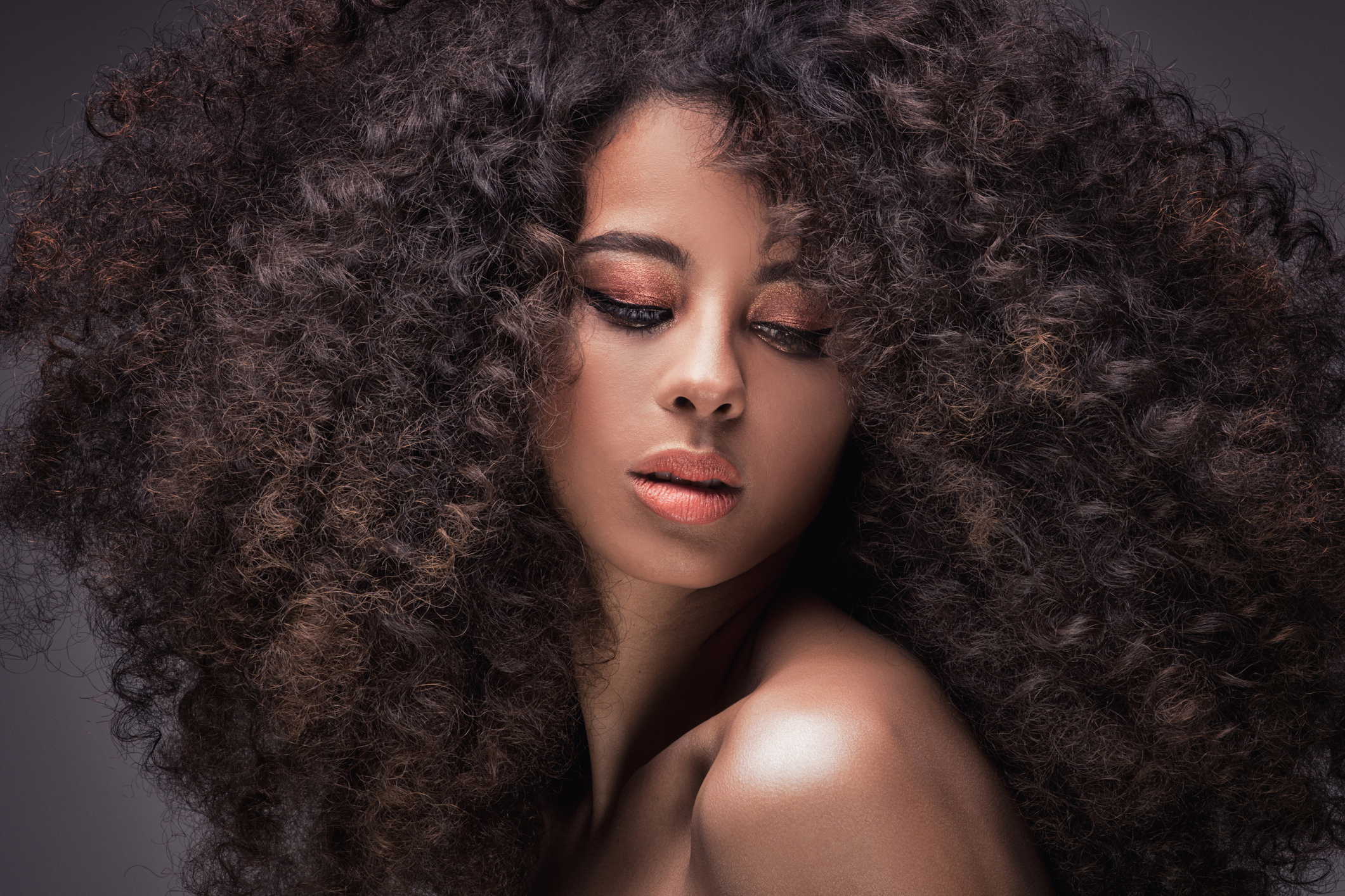 Beauty portrait of sensual african american woman with long curly hair .